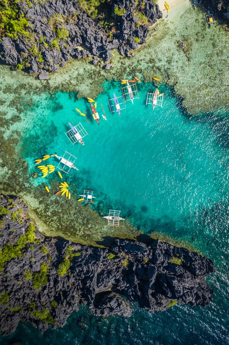 Photo by Jules Bassoleil aerial view of white and brown boat on sea during daytime